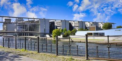 Berlin, Germany, 2021 - Paul Loebe Parliament building along the Spree river and footbridge, Government district in Berlin Mitte, Berlin, Germany photo