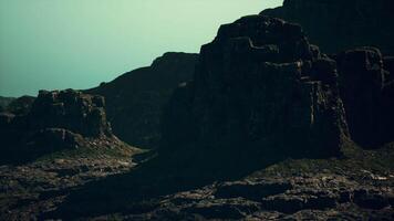 A large rock formation in the middle of a desert video