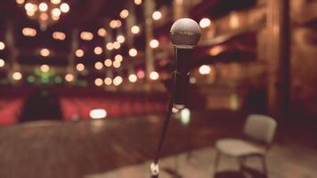 An empty stage with a microphone and chairs video