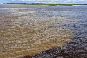 Confluence of the Rio Negro and Solimoes forming the Amazon River, Manaus, Amazonas State, Brazil photo