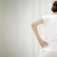 AI generated Asian young woman suffering from low back and loin pain. photo