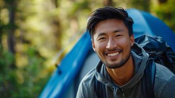 AI generated Portrait of smiling man with backpack standing in front of camping tent photo