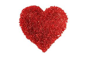 Heart made of red beads on an isolated white background. photo