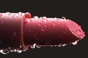 Red lipstick with water drops on a dark background. photo