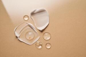 Gel, serum and a cream on a a beige background. photo