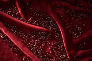 Abstract background from red beads on red velvet. photo