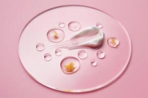 Gel, serum and a cream on a transparent round stand on a pink background. photo