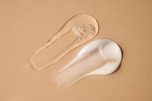 Cosmetic Gel and a cream on a beige background. photo