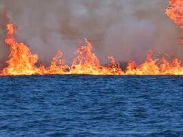 AI generated burning fire in the sea photo