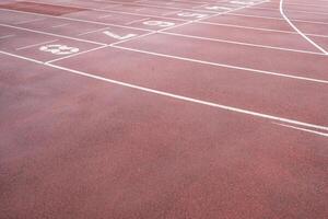 wet synthetic track in the athletics stadium photo