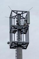 modern mobile radio tower with grey sky photo