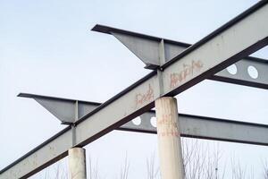 old metal girders of an industrial building against a blue sky photo