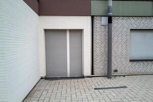 Building with windows and shutters, backyard corner photo