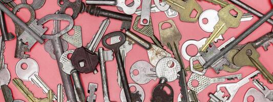 Keys set on pink background. Door lock keys and safes for proper photo