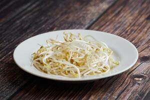 Bean sprouts of mung, maash. Traditional vegan dish in east Asia. Healthy diet food. photo