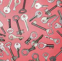 Keys set on pink background. Door lock keys and safes for proper photo