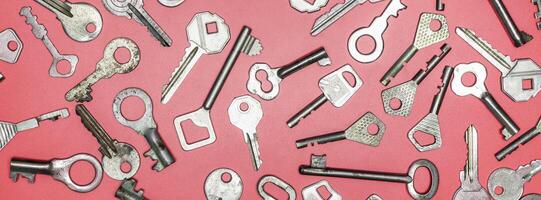 Keys set on pink background. Door lock keys and safes for proper photo