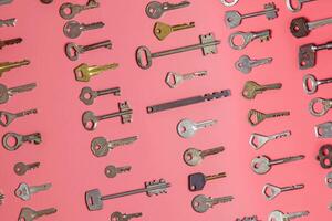 Keys set on pink background. Door lock keys and safes for proper photo