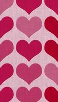 Vertical video - cute Valentine hearts pattern on fabric texture background in red and pink color tones. This textured romantic Valentine's Day motion background design is HD and looping.