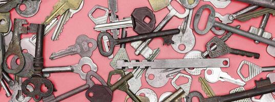 Keys set on pink background. Door lock keys and safes for proper photo