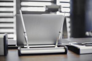 Laptop in office workplace. Business work place for chief, boss or other employees. Notebook on work table. photo