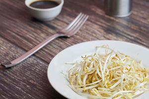 Bean sprouts of mung, maash. Traditional vegan dish in east Asia. Healthy diet food. photo