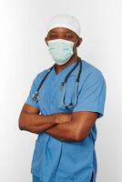 Black surgeon doctor man in blue coat white cap and surgeon mask isolated on white background photo