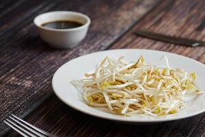 Bean sprouts of mung, maash. Traditional vegan dish in east Asia. Healthy diet food. photo