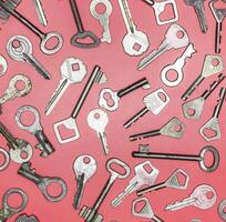 Keys set on pink background. Door lock keys and safes for proper photo