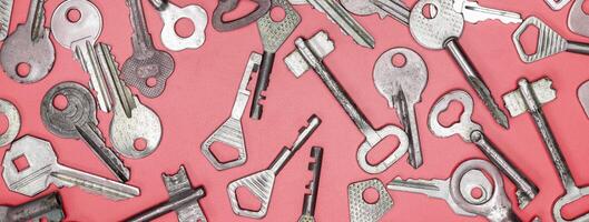 Keys set on pink background. Door lock keys and safes for proper photo