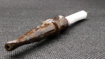 Indonesian wooden pipe for smoking photo