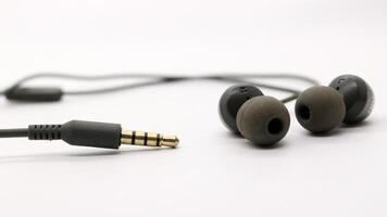 Close up of black wired earphones photo