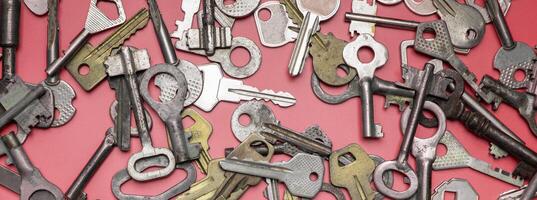 Keys set on pink background. Door lock keys and safes for proper photo