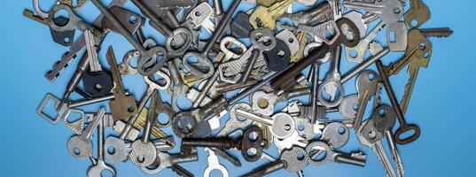 Keys set on blue background. Door lock keys and safes for property security and house protection. Different antique and new types of keys. photo