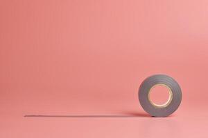 Electrical tape roll, copy space. Minor repairs in house concept. Minimal pink background. photo