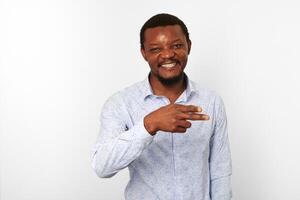 Happy african american black man with pointing finger in casual bright shirt isolated background photo