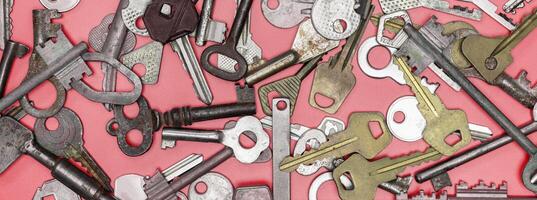 Keys set on pink background. Door lock keys and safes for proper photo