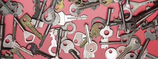 Keys set on pink background. Door lock keys and safes for proper photo