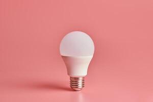 Energy saving light bulb, copy space, pink background. Minimal idea concept. photo