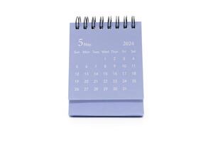 Simple blue desk calendar for MAY 2024 isolated on white background. Calendar concept with copy space. photo