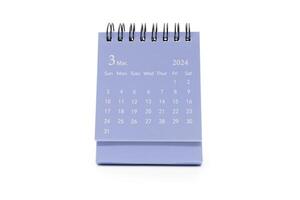 Simple blue desk calendar for March 2024 isolated on white background. Calendar concept with copy space. photo