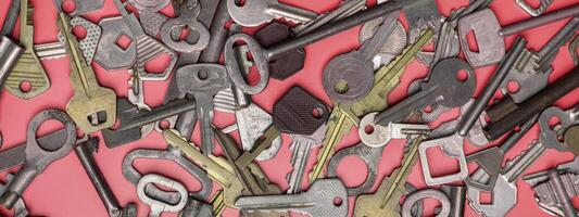 Keys set on pink background. Door lock keys and safes for proper photo