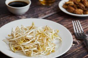 Bean sprouts of mung, maash. Traditional vegan dish in east Asia. Healthy diet food. photo