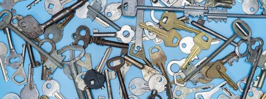 Keys set on blue background. Door lock keys and safes for property security and house protection. Different antique and new types of keys. photo