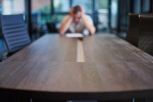 Fired employee in conference room. Manager at table in modern meeting room for business negotiations and business meetings. photo