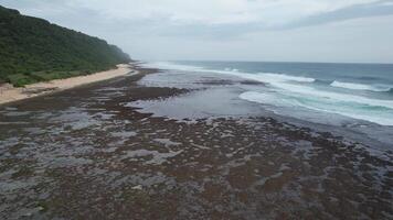 Aerial Nyang Nyang Beach Uluwatu Pecatu Bali - Remote and secluded by cliffs during Sunset video