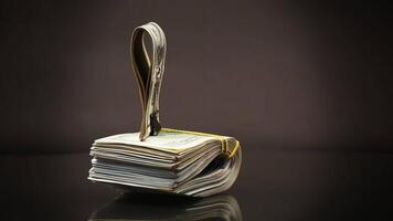 stack of dollar bills collected in an elastic band and a stationery clip video