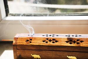 Agarbatti or Incense sticks emitting fragrant smoke. photo