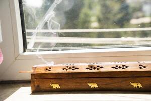 Agarbatti or Incense sticks emitting fragrant smoke. photo