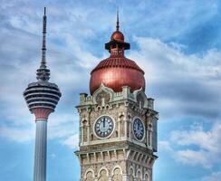 Kuala Lumpur, Malaysia on May 22, 2023. Close up of the clock tower, Big Ben Malaysia. Seen the Kuala Lumpur Tower. Near Masjid Jamek station. photo